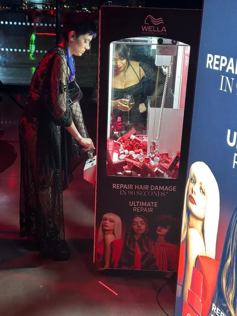 Branded claw machine at a beauty brand launch