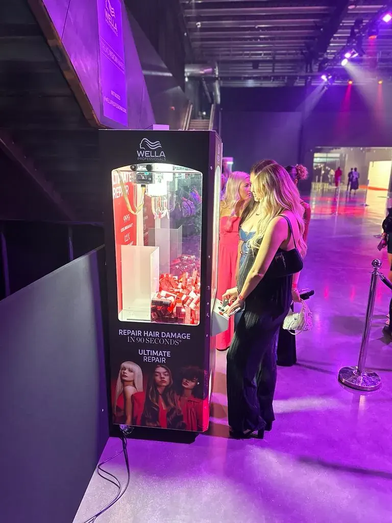 Guest playing a branded claw machine at a launch event