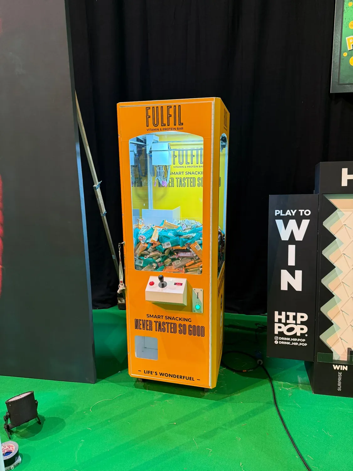Orange branded prize crane with play to win message